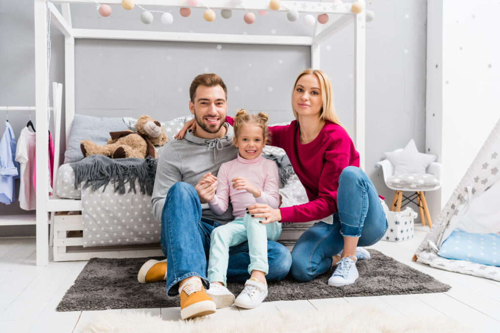 Family portrait in a child's bedroom. Consider Heat Pumps for your home in West Chester, PA, for efficient heating and cooling solutions.